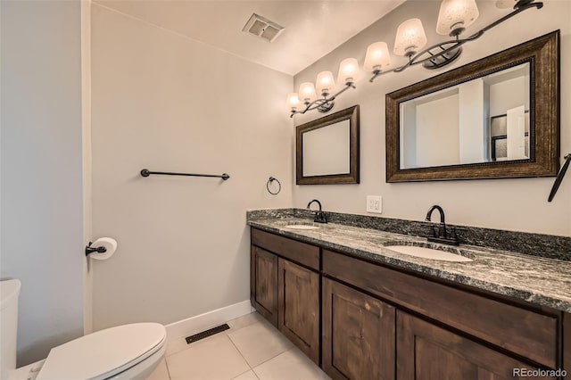 bathroom featuring tile patterned floors, vanity, and toilet