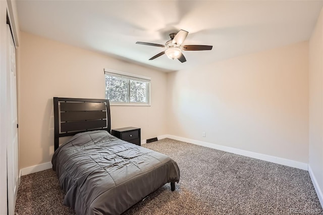 bedroom with ceiling fan and dark carpet