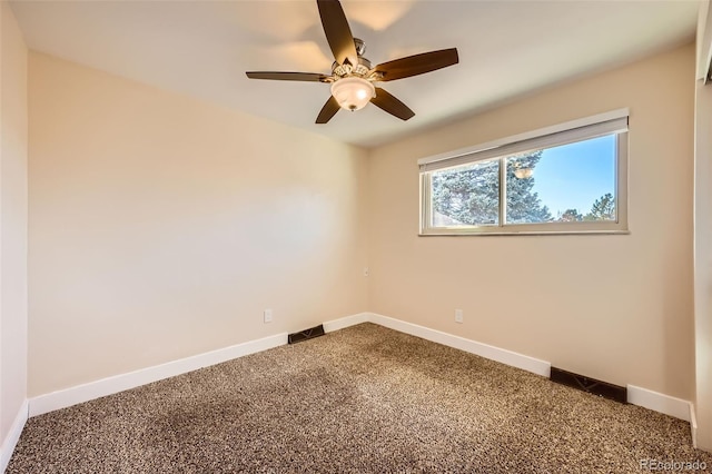 carpeted spare room with ceiling fan