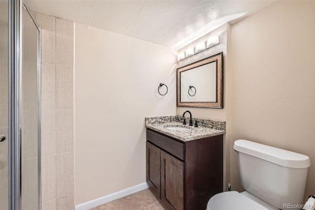 bathroom featuring tile patterned flooring, vanity, and toilet