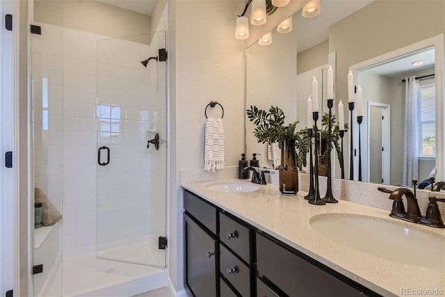 bathroom with a shower with door and vanity