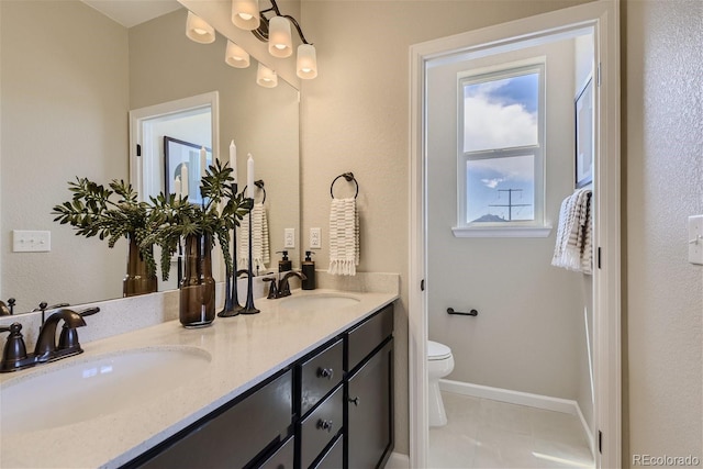 bathroom with tile patterned flooring, vanity, and toilet