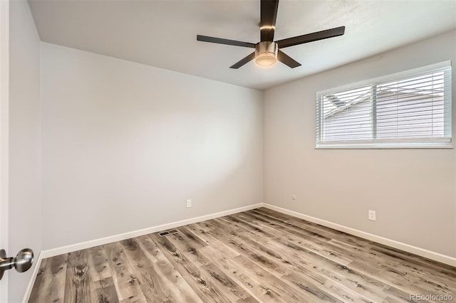 spare room with hardwood / wood-style floors and ceiling fan