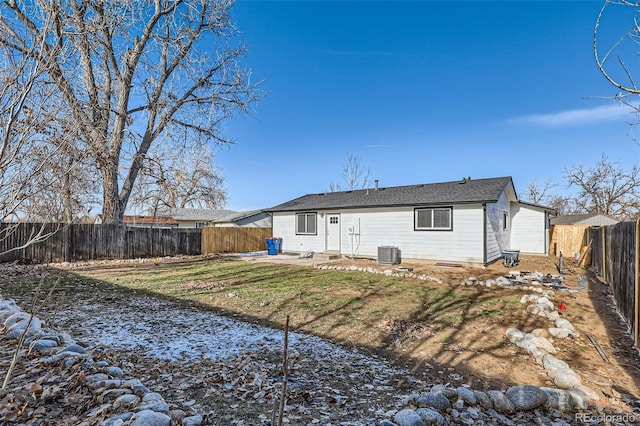 back of property with a lawn and central AC unit