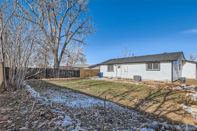 rear view of property with a lawn and central AC