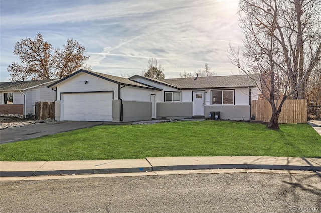 ranch-style house featuring a front yard and a garage