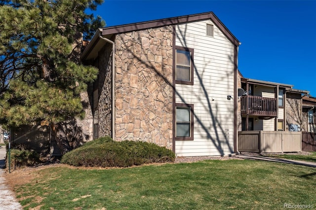 view of front of house featuring a front yard and stone siding