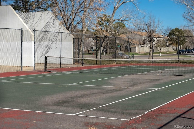 view of tennis court featuring fence