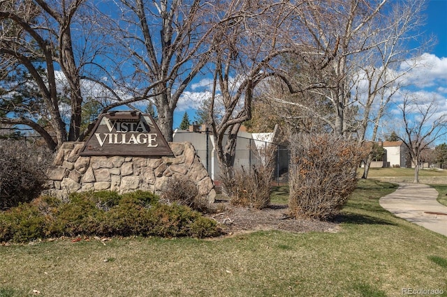 community sign featuring a lawn