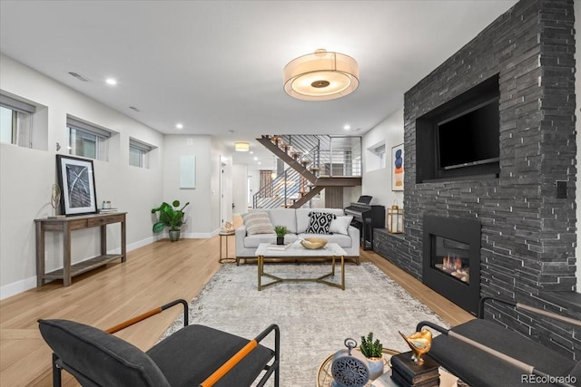 living room with hardwood / wood-style floors and a fireplace