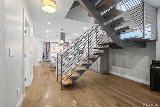 stairway with hardwood / wood-style floors