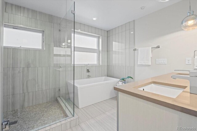 bathroom with vanity, tile patterned flooring, a healthy amount of sunlight, and separate shower and tub