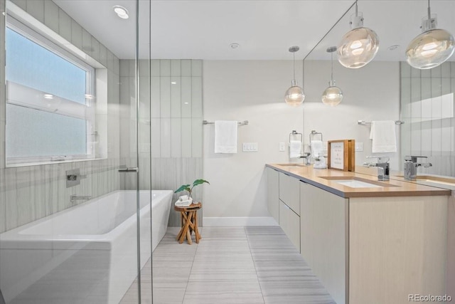 bathroom with vanity, tile patterned flooring, and a tub