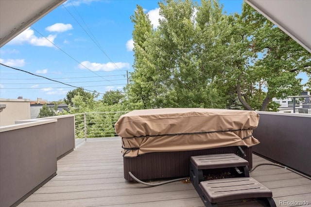 wooden deck with grilling area and a hot tub