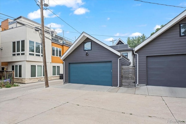 view of front of house featuring a garage and an outdoor structure