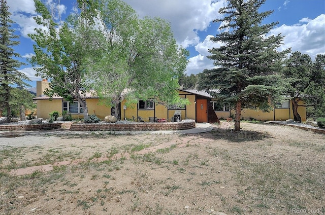 30600 County Road 371, Buena Vista, CO 81211 - view of front facade featuring stucco siding and a chimney