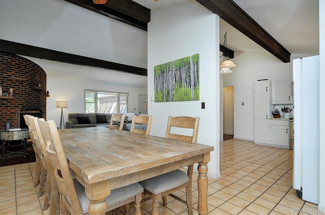 30600 County Road 371, Buena Vista, CO 81211 - dining room with beamed ceiling, light tile patterned floors, a brick fireplace, and high vaulted ceiling