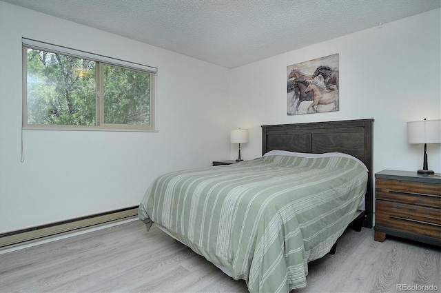 30600 County Road 371, Buena Vista, CO 81211 - bedroom featuring wood finished floors, a baseboard heating unit, and a textured ceiling