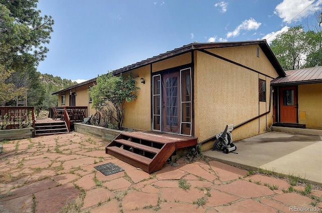 30600 County Road 371, Buena Vista, CO 81211 - back of house featuring stucco siding, a patio, a metal roof, and a deck