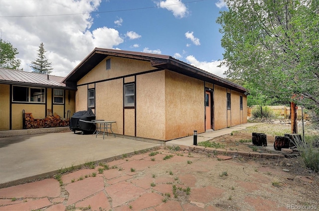 30600 County Road 371, Buena Vista, CO 81211 - view of side of property with a patio area, stucco siding, and a metal roof