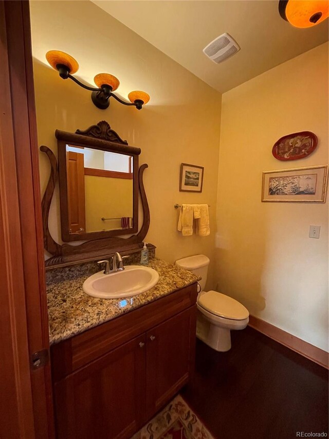 bathroom featuring vanity and toilet