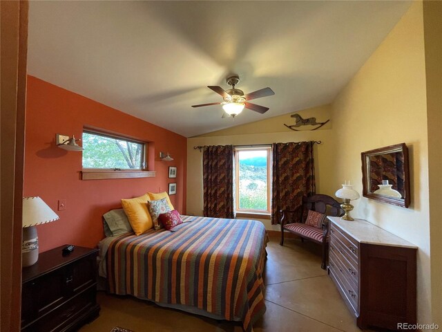 bedroom with vaulted ceiling, multiple windows, and ceiling fan