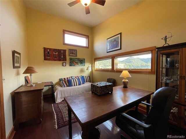 dining room with dark hardwood / wood-style flooring and ceiling fan