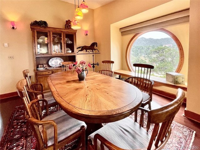 dining space with a mountain view and hardwood / wood-style floors