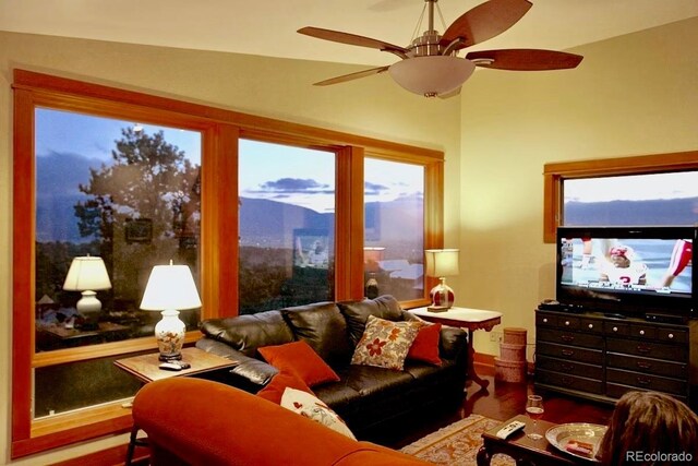 living room with lofted ceiling, ceiling fan, hardwood / wood-style floors, and plenty of natural light