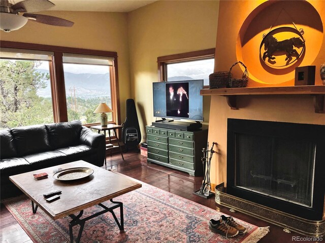 living room featuring dark hardwood / wood-style floors and ceiling fan