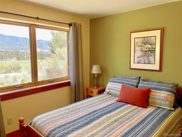 bedroom featuring a mountain view