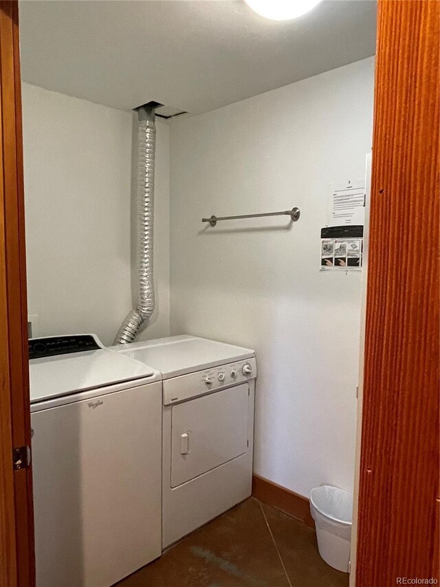 clothes washing area with tile patterned floors and independent washer and dryer