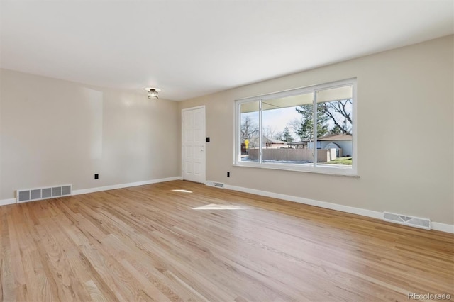 spare room with light hardwood / wood-style flooring