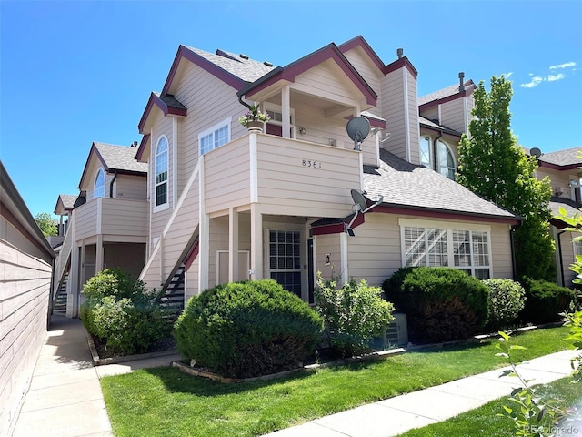 8361 S Upham Way Unit 209, Littleton, CO 80128 - multi unit property featuring a shingled roof, a front lawn, and stairs