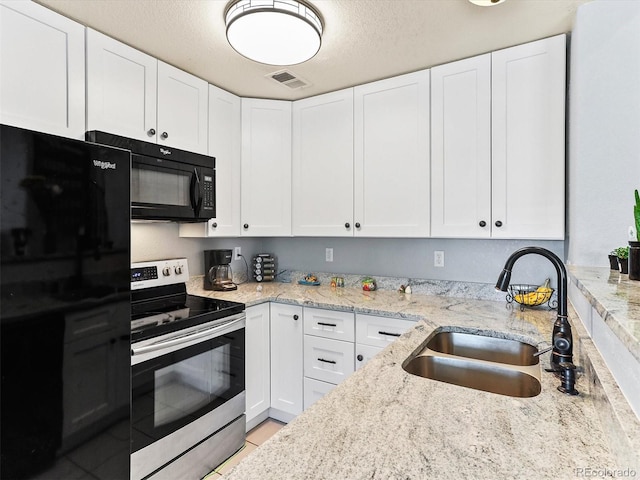 8361 S Upham Way Unit 209, Littleton, CO 80128 - kitchen with electric stove, black microwave, a sink, white cabinetry, and a textured ceiling