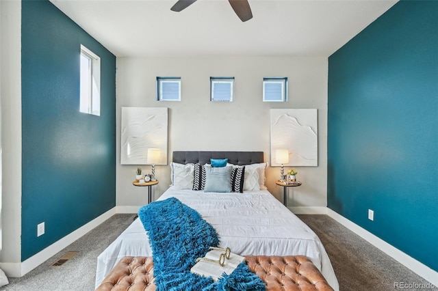 carpeted bedroom with baseboards, a ceiling fan, visible vents, and multiple windows