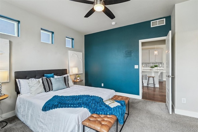 bedroom with baseboards, ceiling fan, carpet flooring, and visible vents