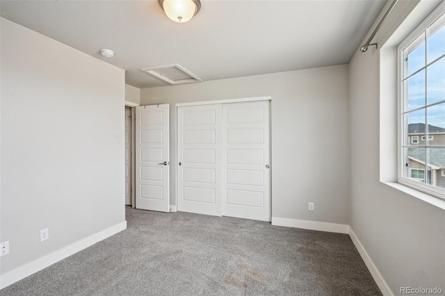 unfurnished bedroom with baseboards, a closet, and carpet