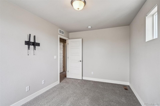 unfurnished bedroom with carpet floors, baseboards, and visible vents