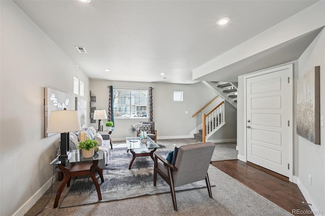 living room with wood finished floors, stairs, visible vents, baseboards, and recessed lighting