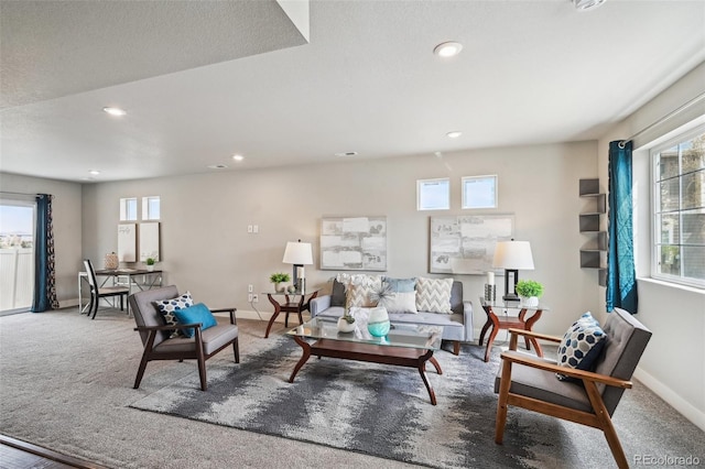 carpeted living room with baseboards, recessed lighting, and plenty of natural light