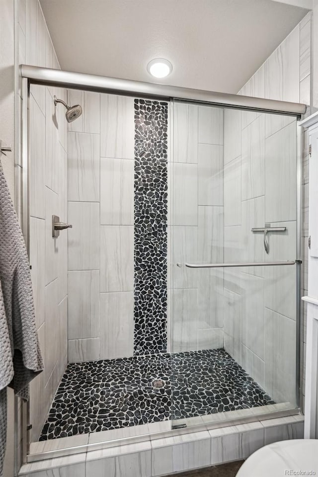 bathroom with a stall shower and recessed lighting