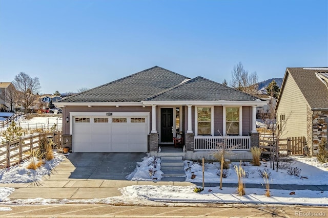 view of front of home with covered porch and a garage