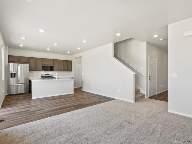 544 97th Ave, Greeley, CO 80634 - kitchen with stainless steel appliances, recessed lighting, open floor plan, a center island with sink, and light countertops