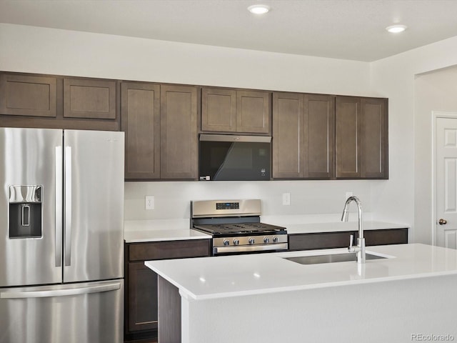 544 97th Ave, Greeley, CO 80634 - kitchen featuring stainless steel appliances, light countertops, dark brown cabinetry, recessed lighting, and an island with sink