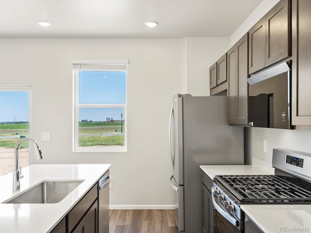 544 97th Ave, Greeley, CO 80634 - kitchen featuring appliances with stainless steel finishes, dark wood-style flooring, light countertops, dark brown cabinetry, and recessed lighting