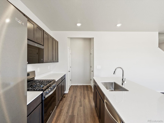 544 97th Ave, Greeley, CO 80634 - kitchen with appliances with stainless steel finishes, dark brown cabinets, light countertops, dark wood finished floors, and recessed lighting