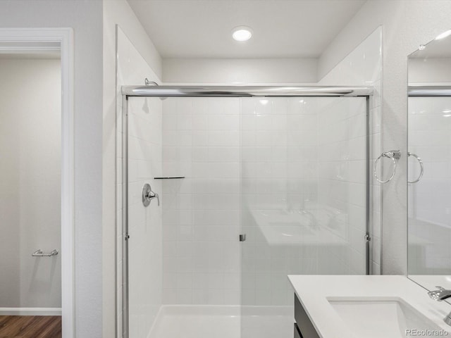 544 97th Ave, Greeley, CO 80634 - full bathroom with a stall shower, vanity, and wood finished floors