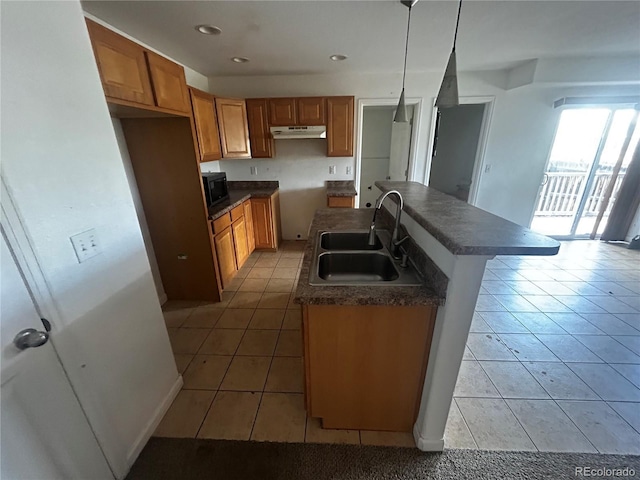 2005 W 86th Ave, Denver, CO 80260 - kitchen with under cabinet range hood, light tile patterned floors, dark countertops, black microwave, and recessed lighting