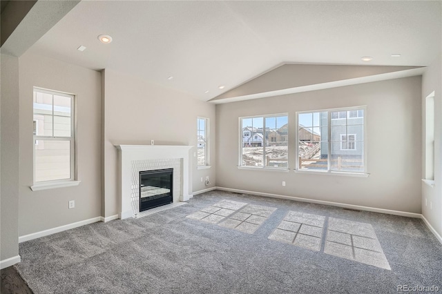 unfurnished living room featuring baseboards, carpet floors, recessed lighting, a fireplace, and vaulted ceiling